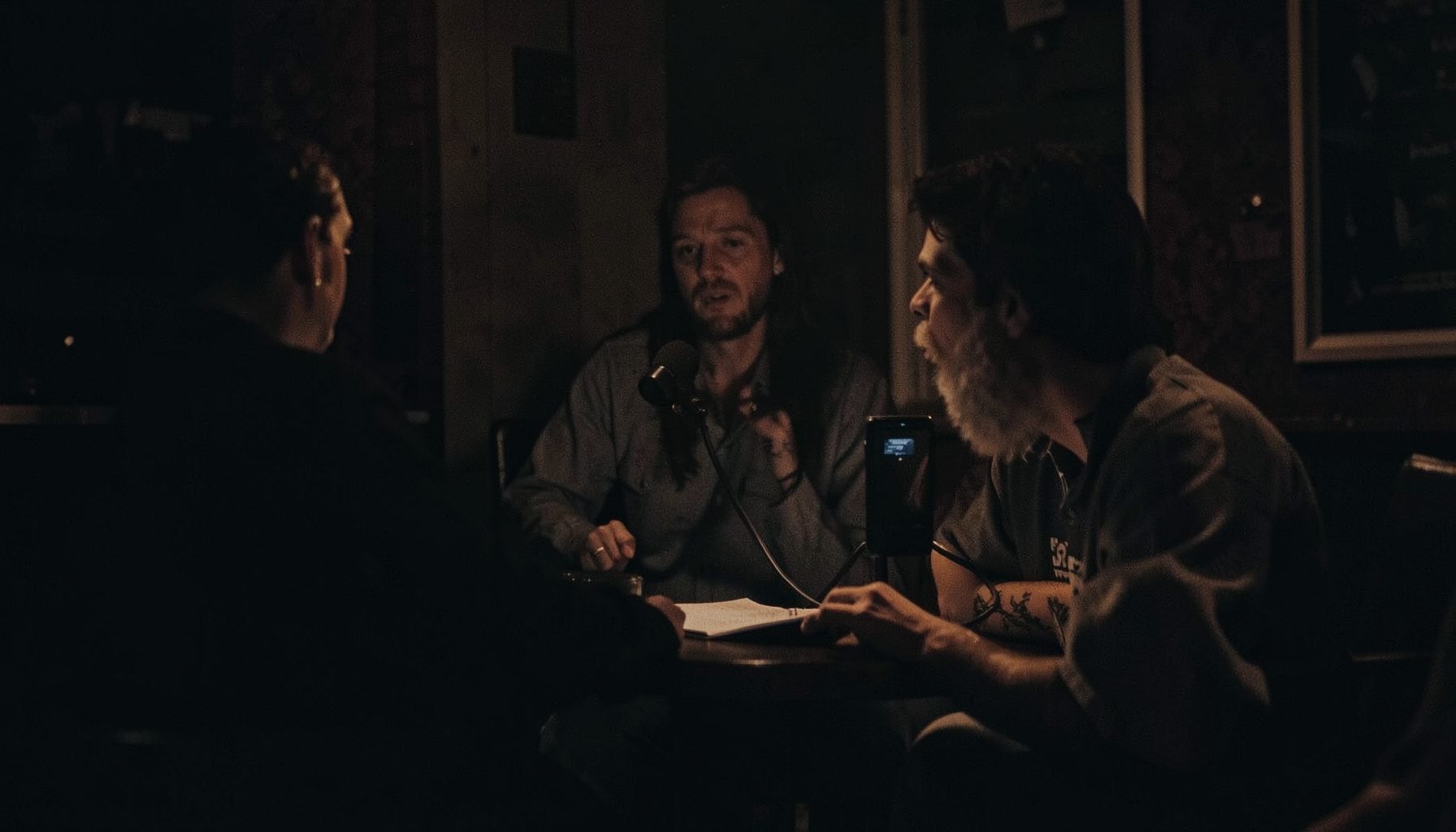 A dark atmospheric texture with subtle warm highlights, evoking the mood of a late-night comic reading session